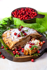 Delicious cranberry pie with fresh cranberries and herbs for Christmas on wooden plate - 498512422