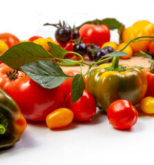 Assorted tomatoes and vegetables isolated on white background. Photo for your design. - 498512424