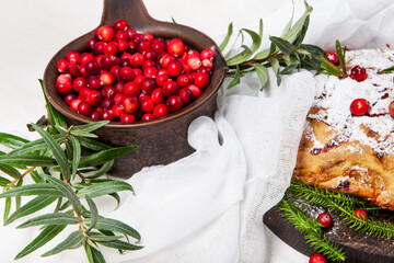 Delicious cranberry pie with fresh cranberries and herbs for Christmas on wooden plate - 498512426