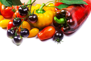 Assorted tomatoes and vegetables isolated on white background. Photo for your design. - 498512427