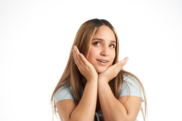 Fototapeta premium Young sweet smiling girl with her hands on her face