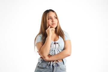 young girl thinking with her hand pressed on her face