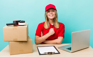 pretty blonde woman feeling happy and facing a challenge or celebrating. packer employee concept