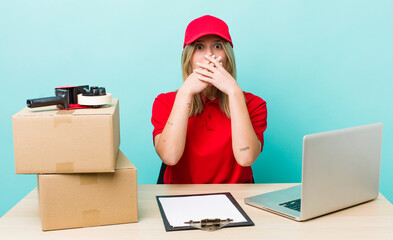 pretty blonde woman covering mouth with hands with a shocked. packer employee concept