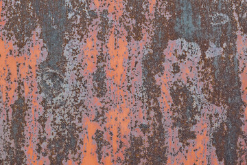 Rusting metal surface. Texture of worn and rusty metal surface with remains of several layers of red paint, high resolution.