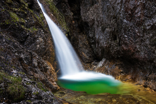 Awe Waterfall with Emerald green Natural water Pool in Slovenian Alps