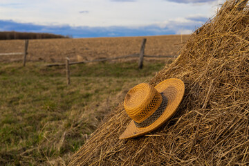 straw hat in countryside with selective focus