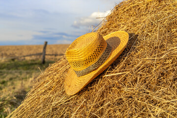 straw hat in countryside with selective focus