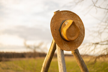 straw hat in countryside with selective focus