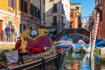 VENICE, ITALY - August 27, 2021: View of empty gondola on narrow canals of Venice, Italy