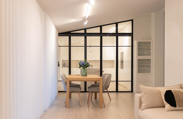 Modern and minimalist dining room and kitchen with industrial glass door