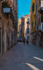 Fototapeta na wymiar VENICE, ITALY - August 27, 2021: People walking by over Venice streets during the pandemic