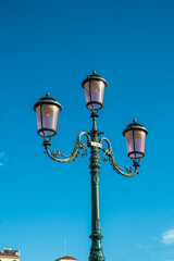 Fototapeta na wymiar Typical Venetian lamppost with a blue background