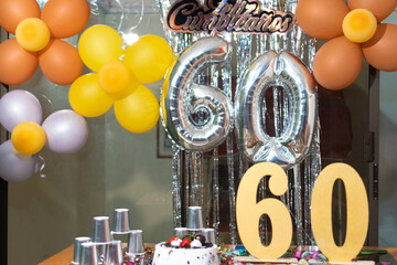Decoration with number 60 balloons at birthday party