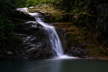Fototapeta na wymiar Europe Forest Small Waterfall in Wilderness