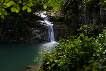 Idyllic Green Waterfall with Lagoon Paradise