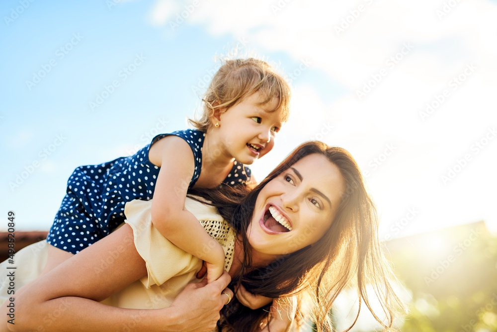 Wall mural having a ball of a time outdoors. shot of a mother bonding with her adorable little daughter outdoor