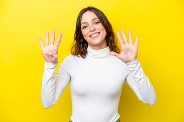 Young caucasian woman isolated on yellow background counting nine with fingers