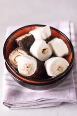 Tasty Turkish delight on Pink Napkin Gray Background Vertical