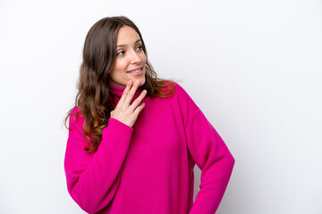 Young caucasian woman isolated on white background looking up while smiling