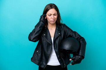 Fototapeta na wymiar Young caucasian woman with a motorcycle helmet isolated on blue background frustrated and covering ears
