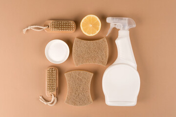 Organic household cleaners set made of natural ingredients, bamboo brush, organic dishcloth, lemon, baking soda, citric acid and spray bottle with cleaning liquid on beige background. Mockup