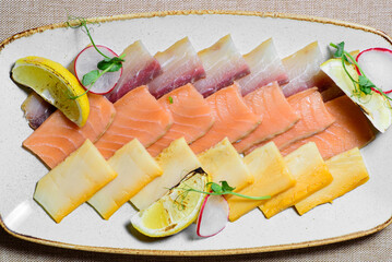 Fish plate with different types of smoked and salted fish