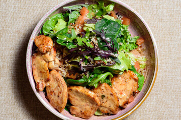 Chicken breast salad with arugula and cherry tomatoes. top view