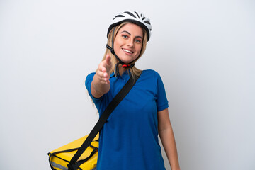 Young caucasian woman with thermal backpack isolated on white background shaking hands for closing a good deal