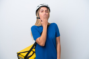 Young caucasian woman with thermal backpack isolated on white background yawning and covering wide open mouth with hand