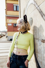 Non binary young woman no makeup outdoor posing laughing having fun