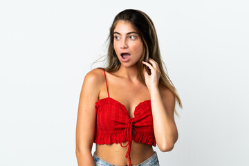 Fototapeta premium Young caucasian woman isolated on white background doing surprise gesture while looking to the side