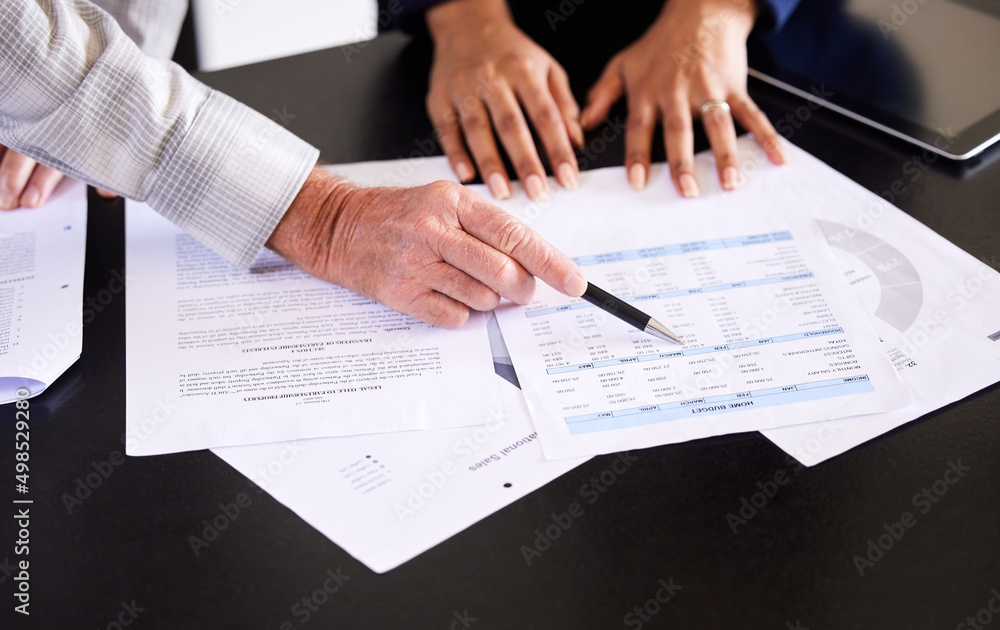 Poster going over his finances. high angle shot of an unrecognizable female broker and her male client goin