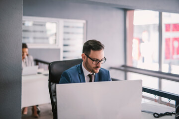 A focused businessman working on computer at office.