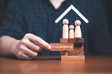 Family standing on wooden block  with hand pulling block which print screen insurance on it for...