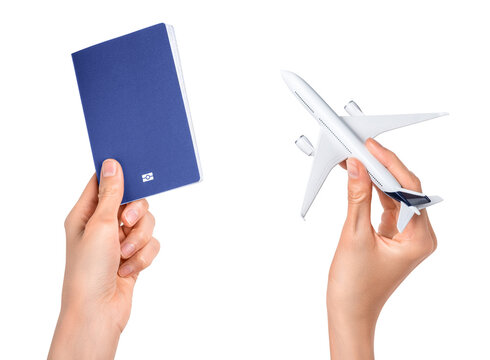 Human hands holding airplane and blue passport isolated on white background. Flight, travel concept