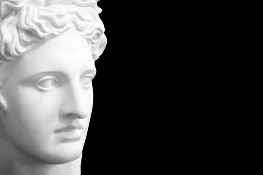 white plaster female statue isolated on black background