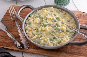 Traditional pea salad with green peas, boiled eggs, onions and mayonnaise