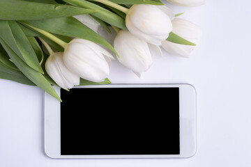 Smartphone mock up and white flowers. Mockup for Floral business. Spring time