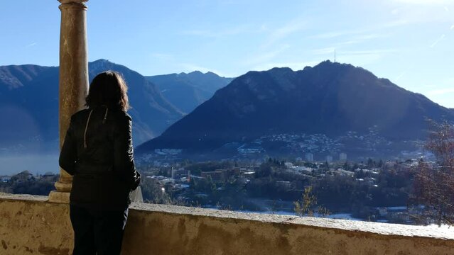 Woman Joy Mountain View and Photographing in a Sunny Day and Cityscape in Lugano, Ticino, Switzerland.
