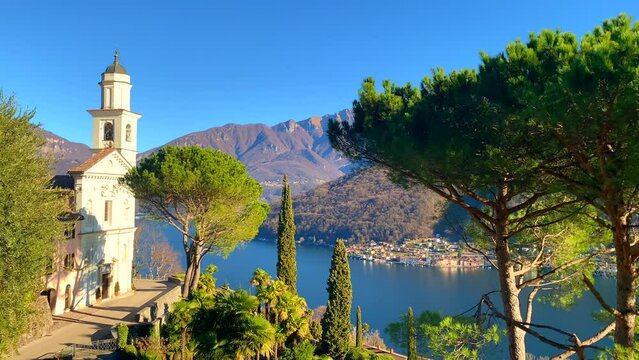 Mountain View and Church San Simone and Fedele with Tree on Lake Lugano in Vico Morcote in Ticino, Switzerland.
