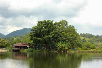 Fototapeta na wymiar Scenic view of a riverside village with lush green surroundings in the outskirts of the town of Ipoh in Malaysia.