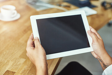 All the right tools at your disposal. Closeup shot of a person holding a digital tablet in a modern office.