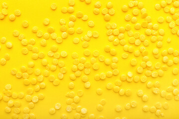 Heap of sprinkles on yellow background