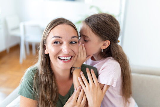 Close up image amazed mother hears incredible news from little daughter, kid girl share secret telling something interesting while mom open mouth feels surprised, trust, confidant person, fun concept