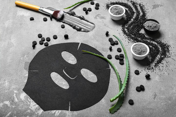 Composition with ingredients for activated carbon facial mask on grunge background