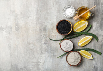 Different ingredients for activated carbon facial mask on grunge background