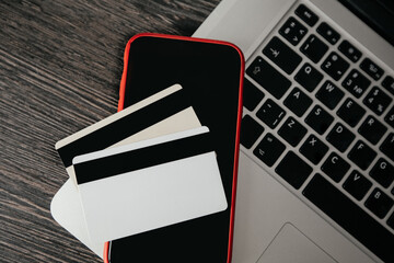 Credit card and smartphone on a laptop