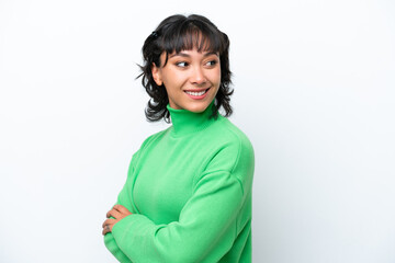 Young Argentinian woman isolated on white background with arms crossed and happy