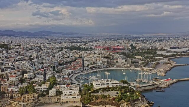 Pireas Greece Aerial v3 establishing shot drone flyover munichia hillside harbor toward peace and friendship indoor arena and karaiskaki stadium at daytime - September 2021
